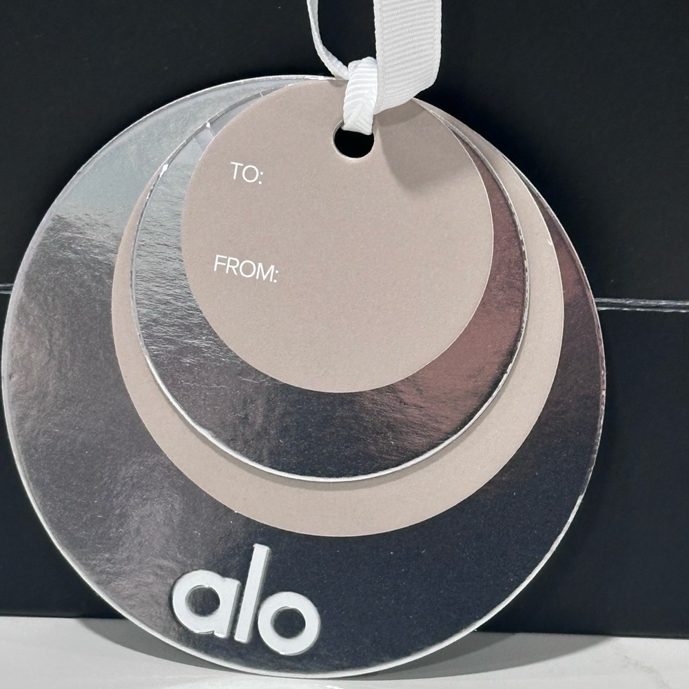 ALO black and white, empty paper bag with tissue paper and holiday gift charm. - Picture 3 of 5